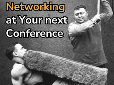 Picture of a man holding a large stone on his stomach while another holds a hammer above it, about to swing it down on the block